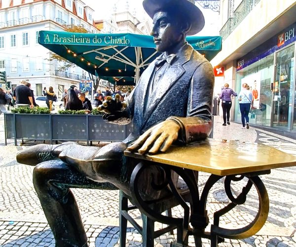 Fernando Pessoa sitting at a table